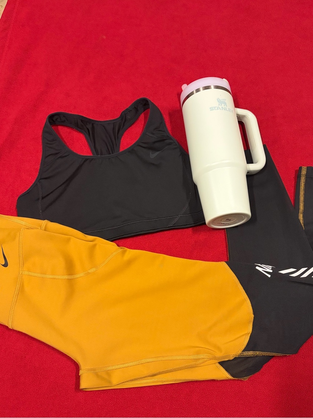 Nike Black Racerback Sports Bra with Yellow Athletic leggings and Stanley